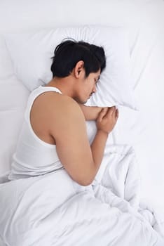 Handsome asian man sleep tightly in his bedroom