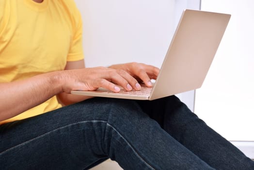 Man typing on laptop at home