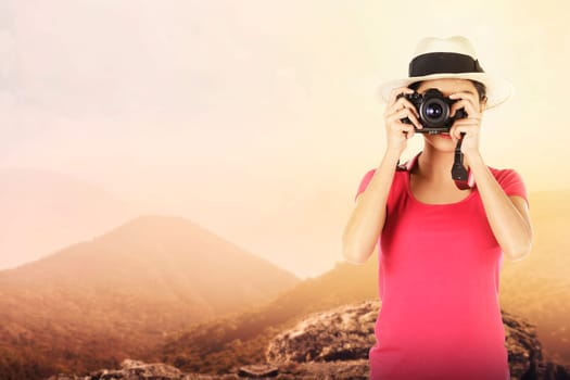 Young Woman Photographer. Taking photo of mountain
