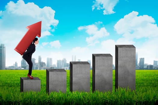 Business woman carry red arrow on her back standing on the chart