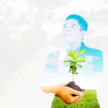Multi exposure asian business man thinking about green plant