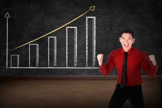 Business person smile over increasing graph drawing on chalk board