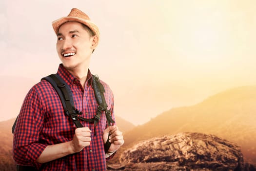 Young asian traveler smiling when hiking on the mountain