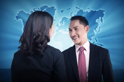 Casual business meeting over world map background