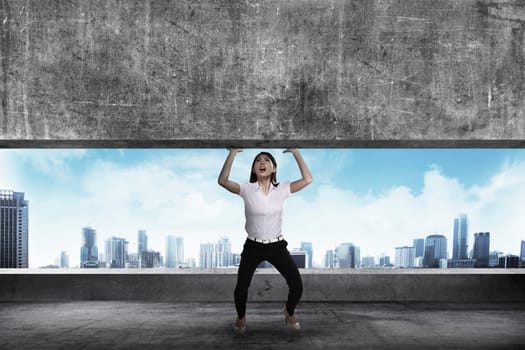 Asian business woman lift heavy block. Business challenge concept