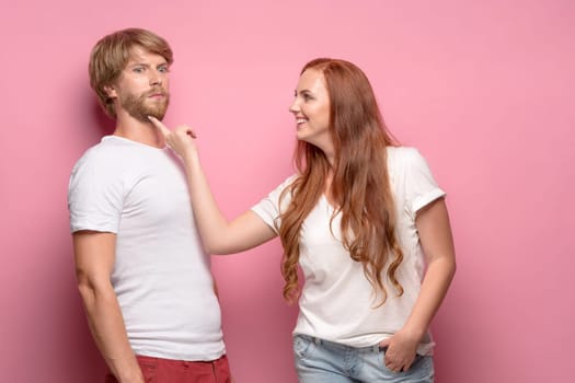 The photo of beautiful couple, studio shoot. The girl seducing a guy