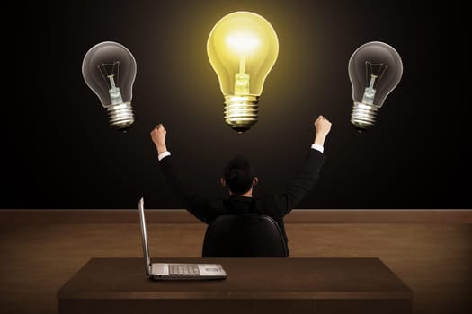 Business person having bright idea light bulb concept over grunge background