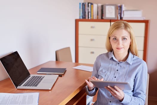 A young businesswoman working on her digital tablet