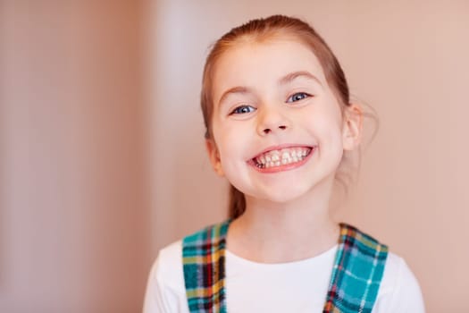 A cute little girl smiling at the camera.