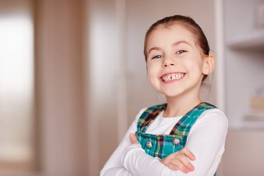 A cute little girl smiling at the camera.