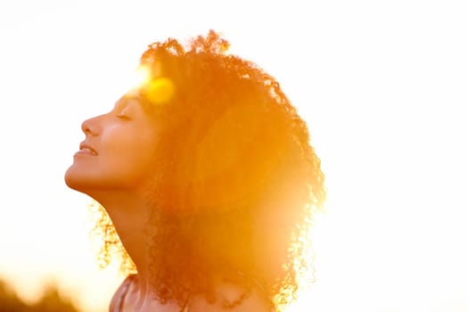 A beautiful young woman enjoying the sunset