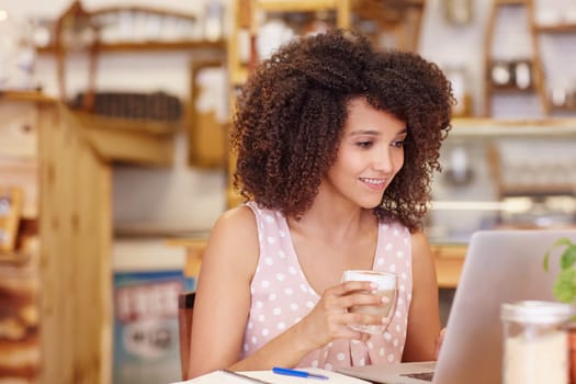 Beautiful mixed race woman connected to the internet by the wifi in the coffee shop is sitting in
