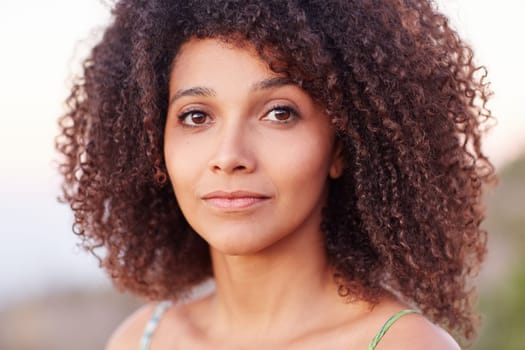 Closeup and intimate portrait of a beautiful mixed race woman looking at the camera outdoors
