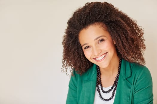 Portrait of a mixed race businesswoman smiling at the camera with a beautiful curly afro hairstyle