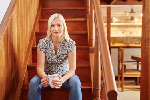 A young woman drinking coffee at home