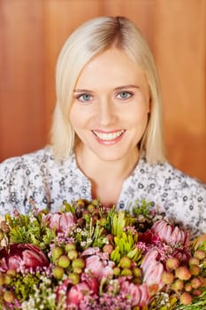 Portrait of a beautiful young woman holding flowers