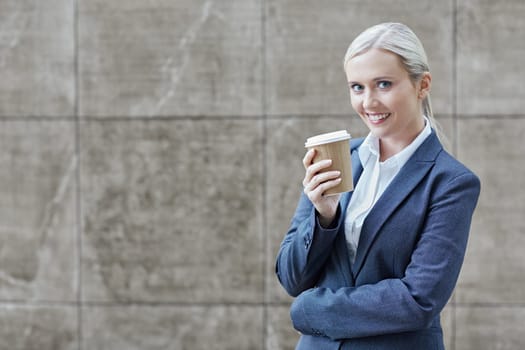 A young businesswoman holding a cup of coffee