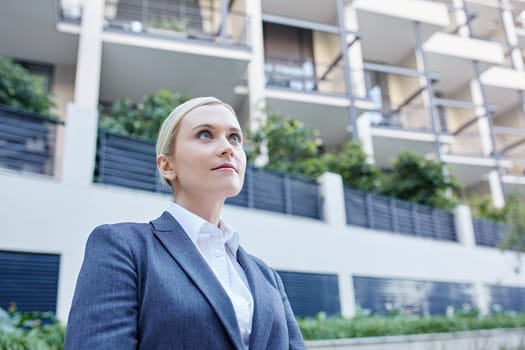 A young businesswoman standing outside a building
