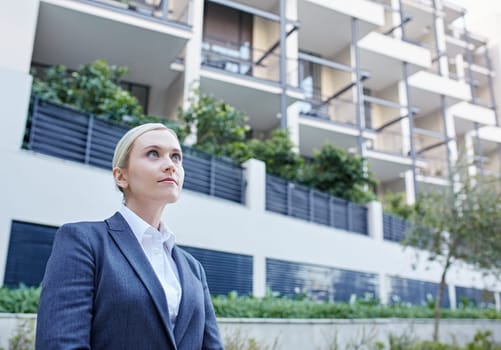 A young businesswoman standing outside a building