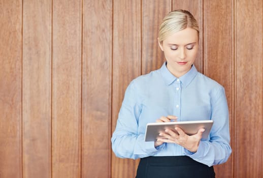 A young businesswoman working on her digital tablet