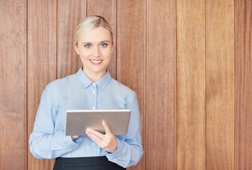 A young businesswoman working on her digital tablet