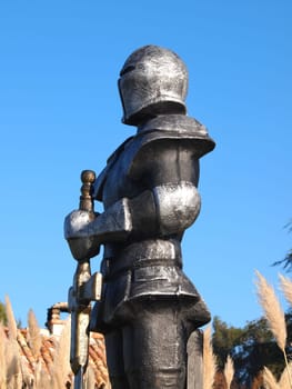 statue of Knight Swordsman in Full Armour standing in front of  museum