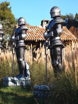 statue of Knight Swordsman in Full Armour standing in front of  museum