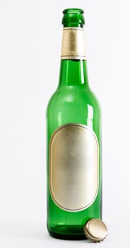 empty green beer bottle with crown seal in light background