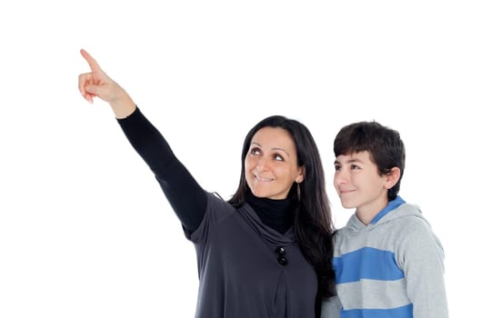 Brunette mother showing something at his teenager son isolated on a white background