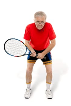 Active man waiting with tennis racquet in his hand.