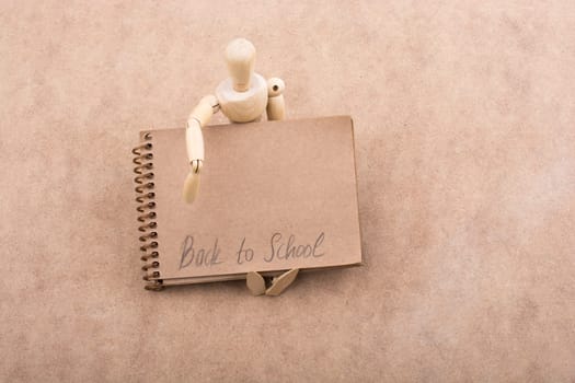 Back to school lettering on a  notebook in arm