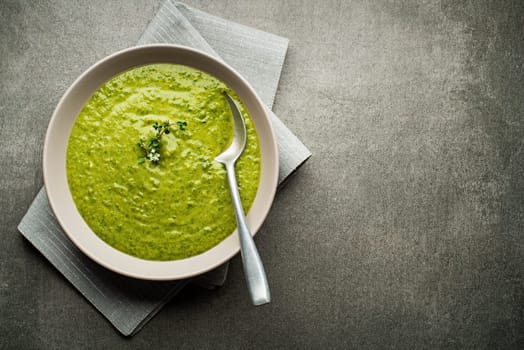 Fresh healthy vegetable green soup overhead shoot.