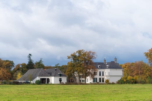 DENEKAMP, NETHERLANDS - NOVEMBER 2, 2016: Singraven mansion with neoclassical frontage in a rural surrounding
