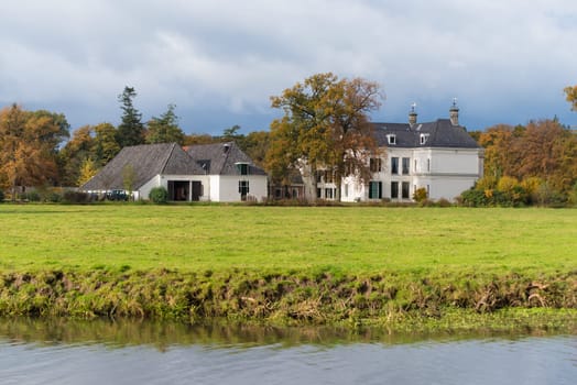 DENEKAMP, NETHERLANDS - NOVEMBER 2, 2016: Singraven mansion with neoclassical frontage in a rural surrounding