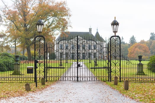 DENEKAMP, NETHERLANDS - NOVEMBER 2, 2016: Singraven mansion with neoclassical frontage in a rural surrounding