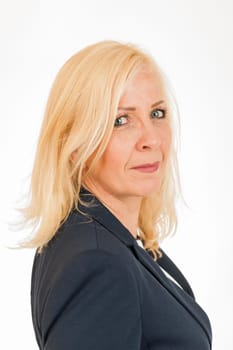 Side head-and-shoulder portrait of a middle-aged blonde woman in a dark blazer isolated on white.