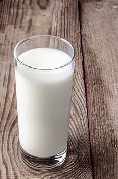 The glass of milk on the old table