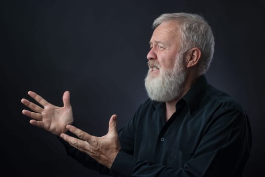 Old man with beard praying for someone and asking for something