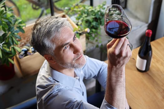 A glass of red wine. Handsome man drinking wine. Man drinking wine.