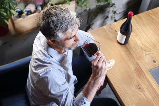 A glass of red wine. Handsome man drinking wine. Man drinking wine.