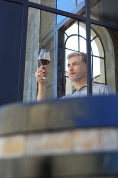 A glass of red wine. Handsome man drinking wine. Man drinking wine.