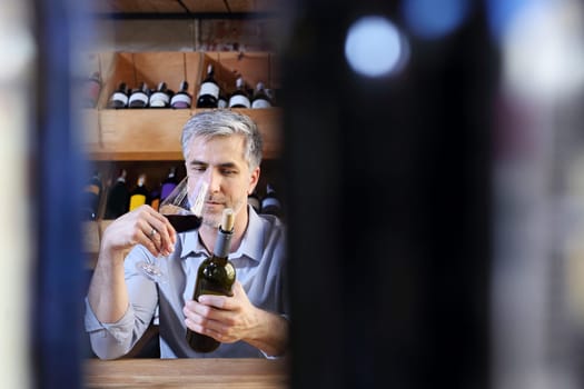 A glass of red wine. Handsome man drinking wine. Man drinking wine.