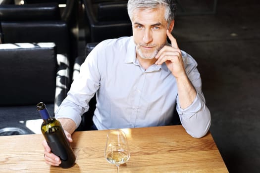 A glass of red wine. Handsome man drinking wine. Man drinking wine.