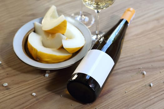 Aperitif, a glass of white wine and melon.