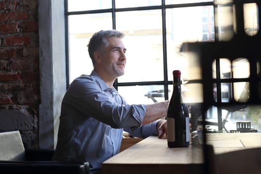 A glass of red wine. Handsome man drinking wine. Man drinking wine.