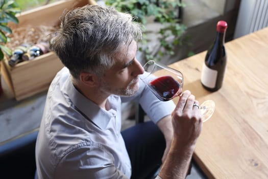 A glass of red wine. Handsome man drinking wine. Man drinking wine.