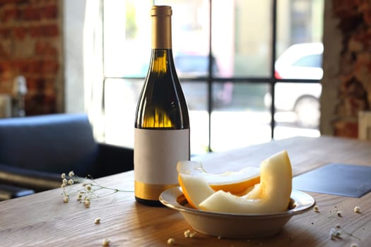Aperitif, a glass of white wine and melon.