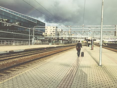 One businessman with luggage goes to the station, A man heading off on a business trip. Thunderstorm is coming