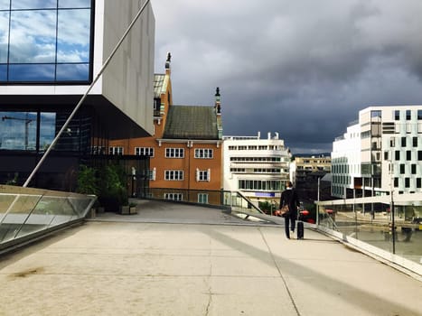 One businessman with luggage goes to the station, A man heading off on a business trip. Thunderstorm is coming