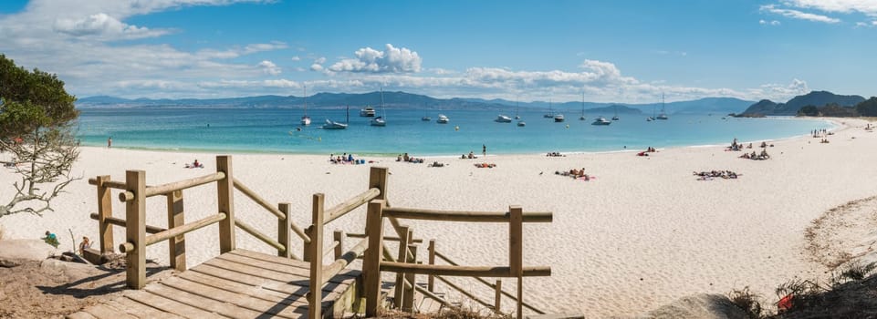 ISLAS CIES, SPAIN - CIRCA SEPTEMBER 2017: Unidentified people relax on the sand beach of Playa de Rodas on the Cies Islands of Spain, included in the Atlantic Islands of Galicia National Park.